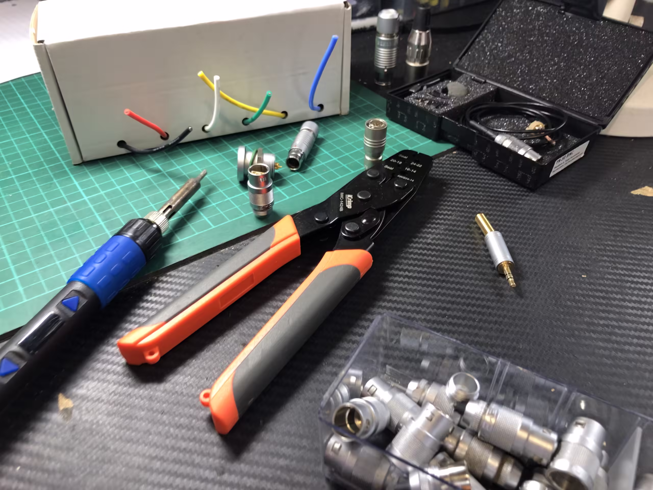 Spools of wire and a lavalier microphone awaiting repairs and a new connector to be attached