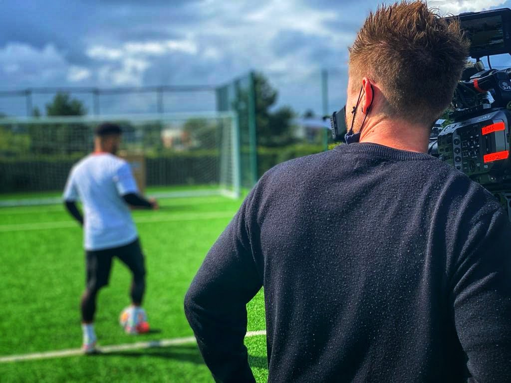 Camera operator Craig Hale filming football training
