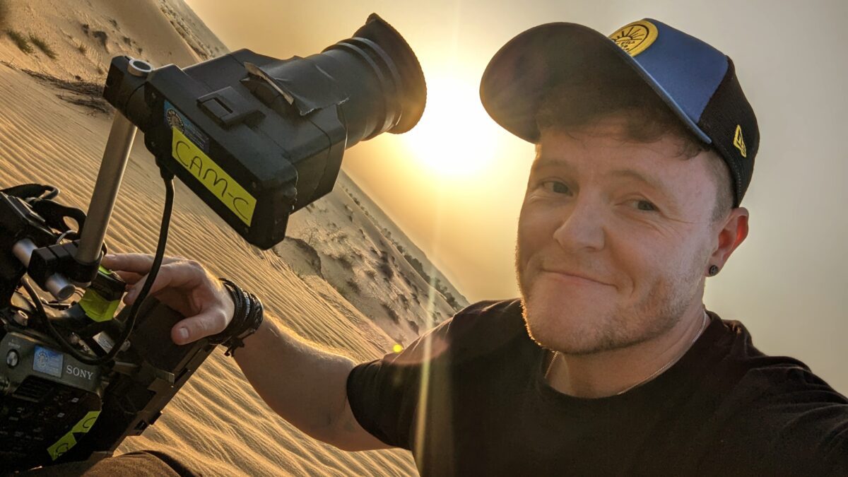 Camera operator Craig Hale in the deserts of Dubai with camera in hand