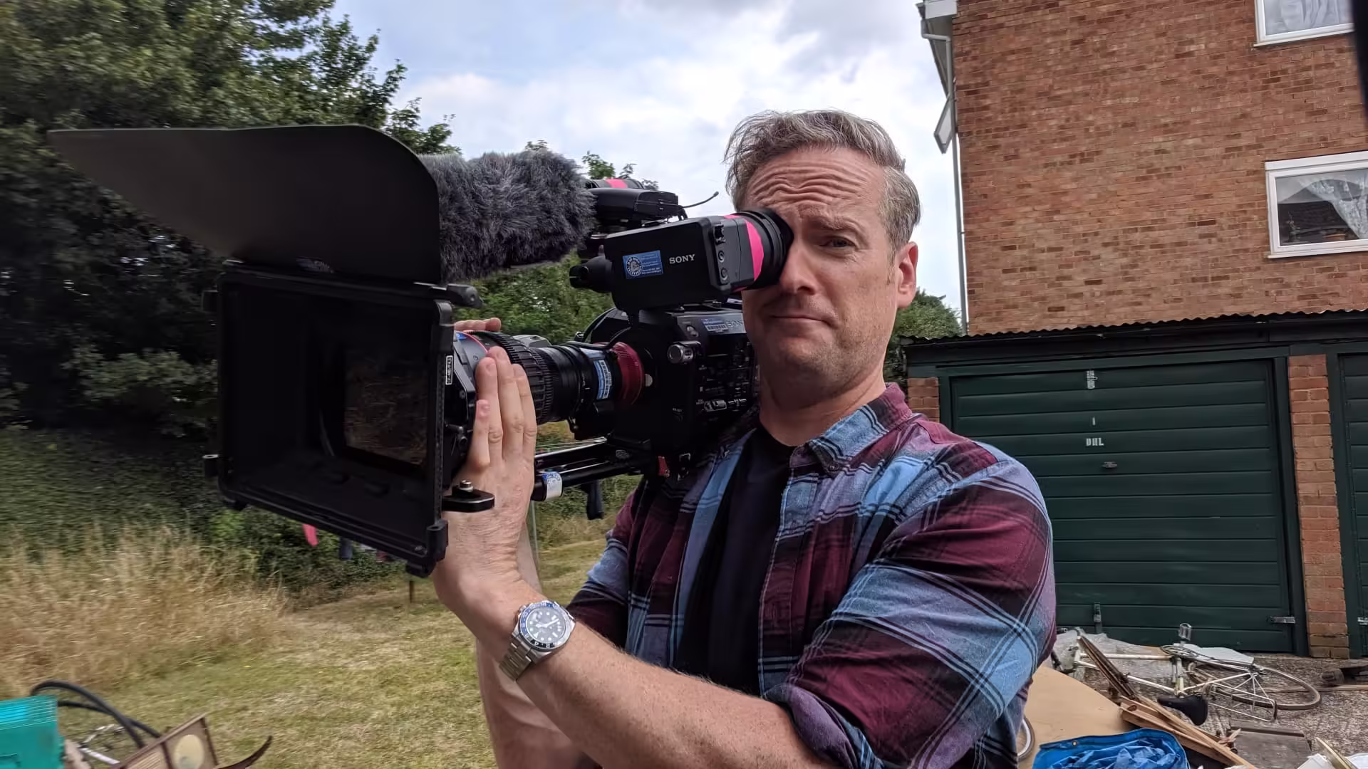 Presenter Tim Shaw holding one of our Sony FS7ii cameras and Canon CN7 whilst filming for Car SOS