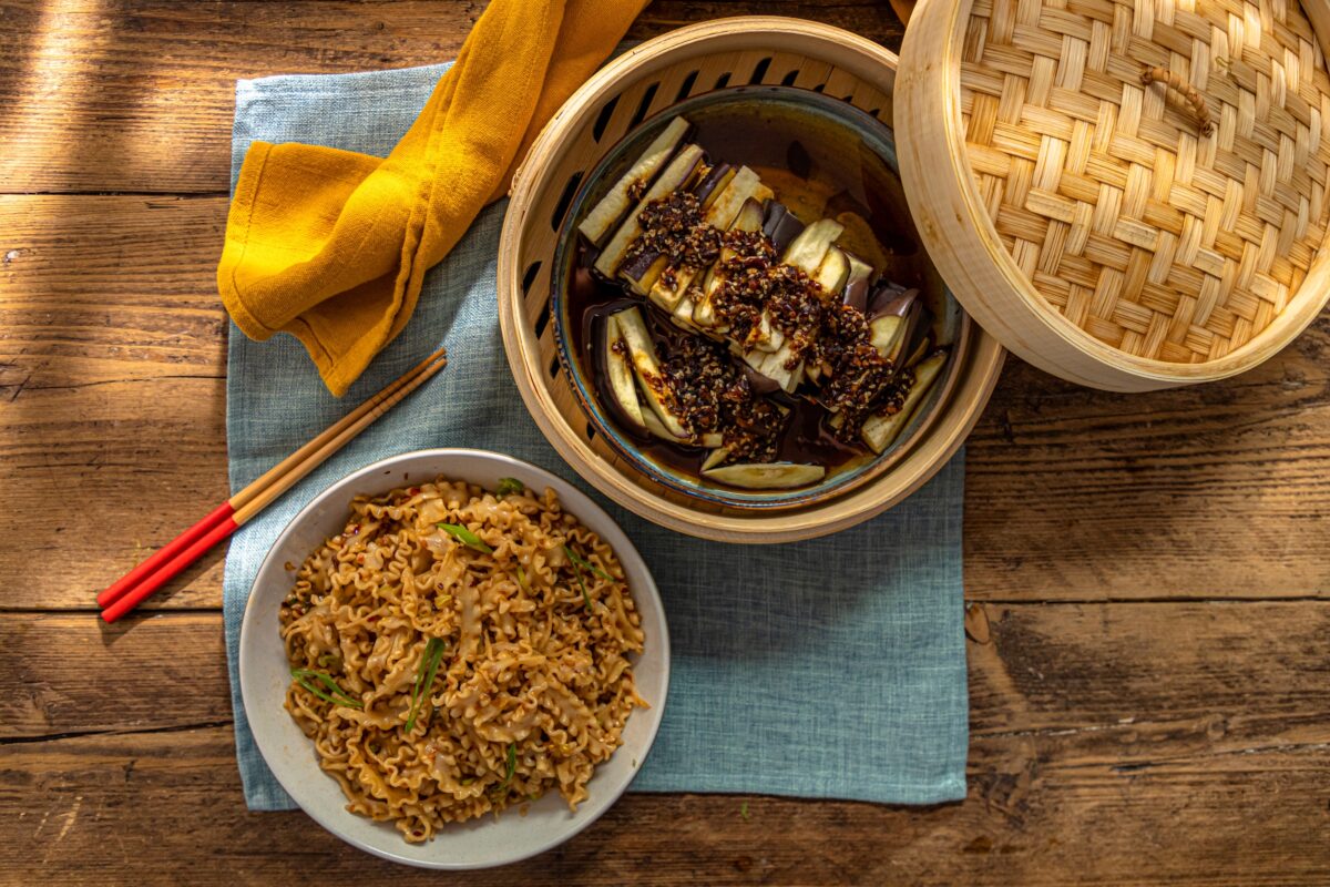 Some Spicy pickled chilli eggplant acompanied by some pad thai with spring onions, Photographed by James Bailey